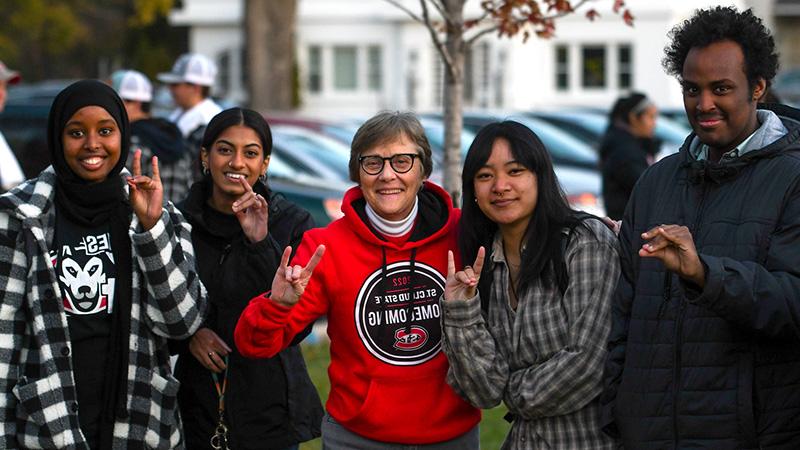 St. Cloud State University President Dr. Robbyn Wacker and four students