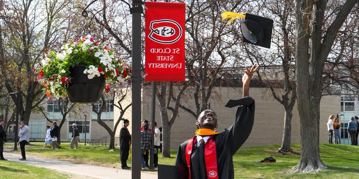 Grad throwing cap into air